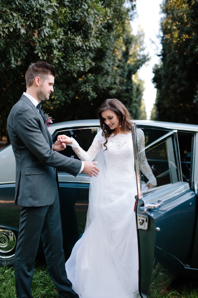 Bride and groom with Daimler DS420 Classic wedding car