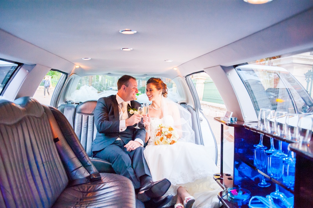 bride and groom in 12 seat wedding car